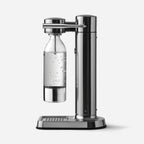 The Aarke Carbonator 3 in Steel with a PET Water Bottle in it on a blank background