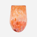 The Amokura Tumbler Glass in Coral on a blank background