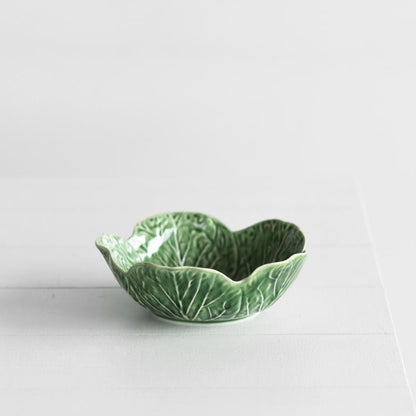 The Bordallo Pinheiro Cabbage Bowl in 17.5 size on a table