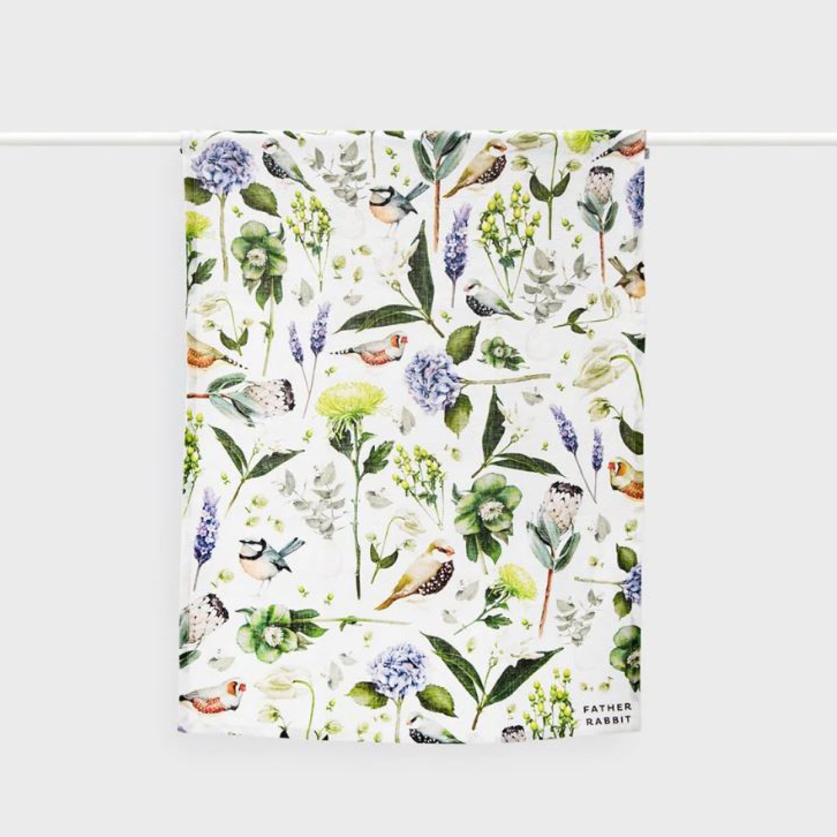 The Father Rabbit Botanica Cream Tea Towel hanging on a rod on a blank background