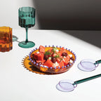 The Fazeek Salad Servers in Teal and Lilac next to a fazeek bowl and glasses