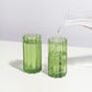 Fazeek Wave Highball Glasses in Green with water being poured into them