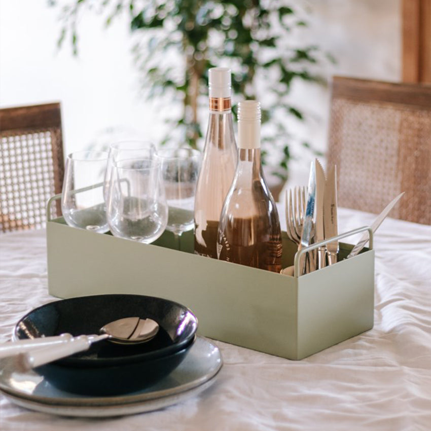 Garcia Metal Planter Box in Sage Green on dining table with wine, glasses and cutlery inside.