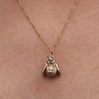 The Meadowlark Bee Charm Necklace in Gold Plated on a model