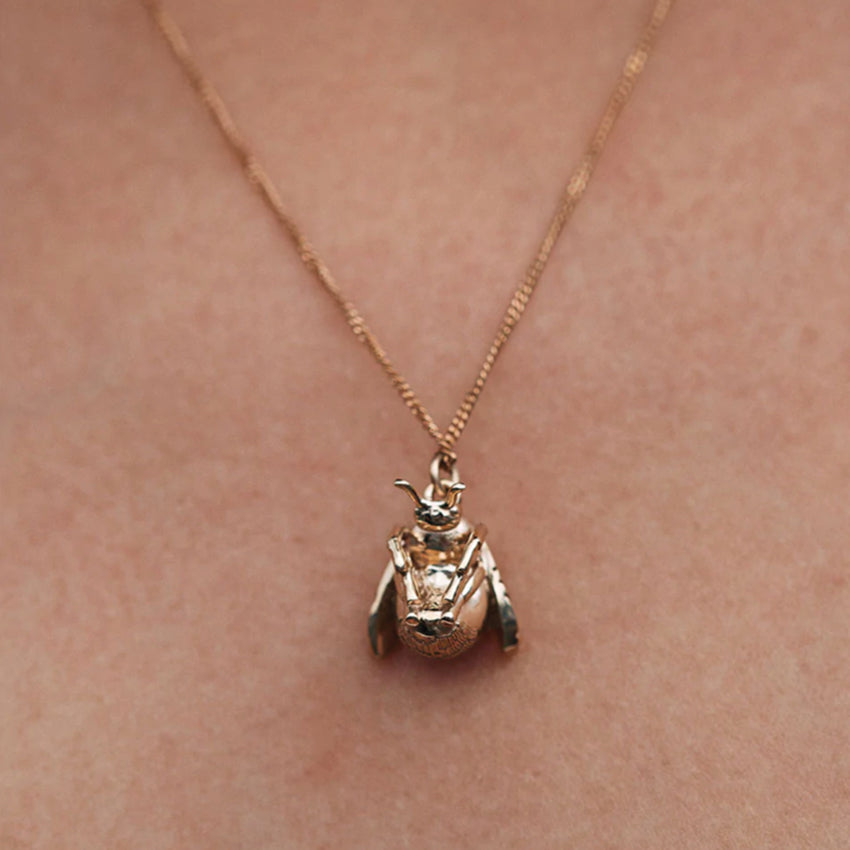 The Meadowlark Bee Charm Necklace in Gold Plated on a model