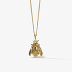 The Meadowlark Bee Charm Necklace in Gold Plated on a blank background