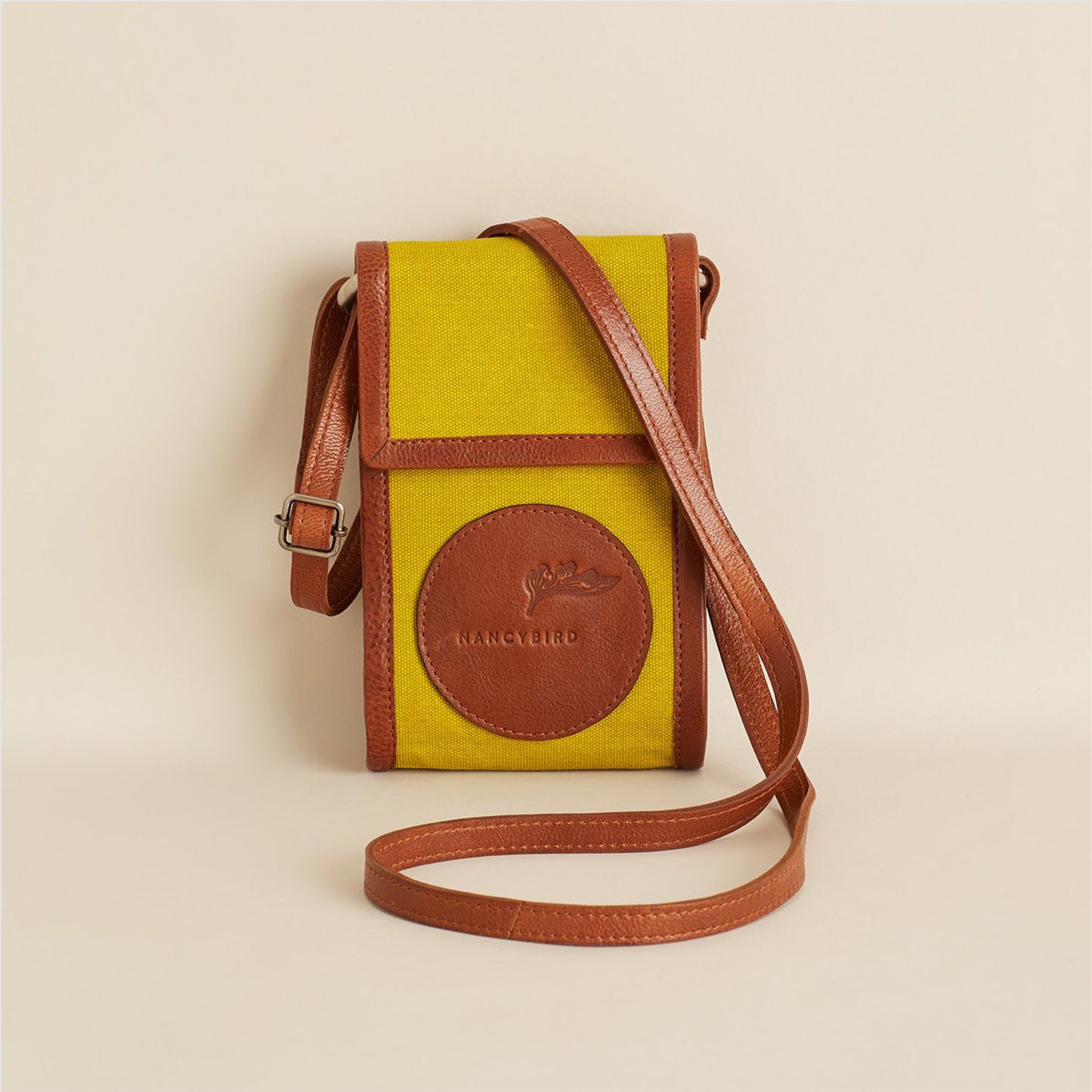 Nancybird Maya Bag in Chartreuse with strap folded over the bag on a neutral background