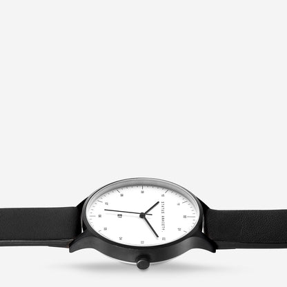 Status Anxiety Inertia Watch in Matte Black with White Face and Black Strap close up view