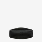 The bottom of the Status Anxiety Point Of No Return Bag in Black on a blank background