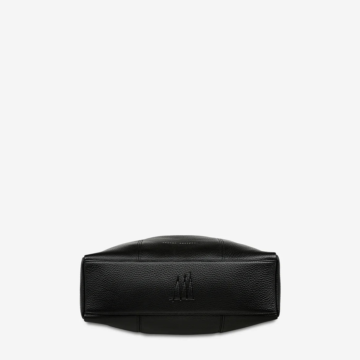 The bottom of the Status Anxiety Point Of No Return Bag in Black on a blank background