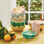 A stack of the Sage x Clare Petal Bowl in different colours on a tablesetting