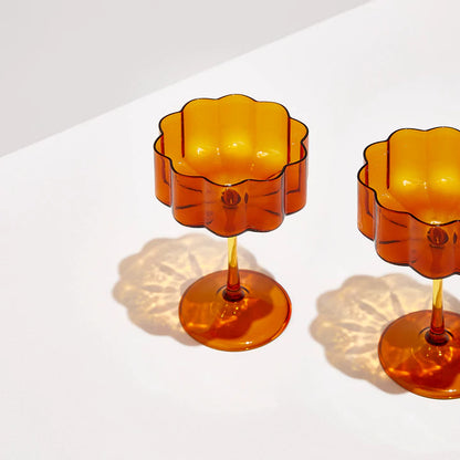 An upper view of the Fazeek Wave Coupe Glasses in Amber on a blank background