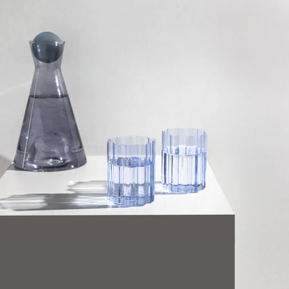 Fazeek Wave Glasses in Blue on table with water in them and decanter 